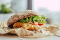 Fried fish Sandwich with lettuce, tomato with tartar sauce. author`s recipe street food Royalty Free Stock Photo